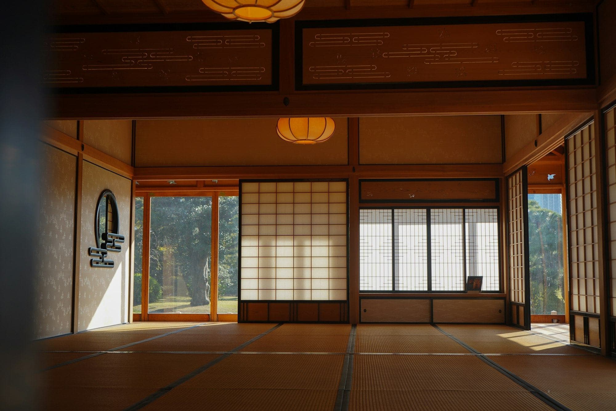 A tatami room lit by a paper lantern and shoji screens